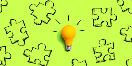 Jigsaw puzzle with a yellow light bulbの写真素材