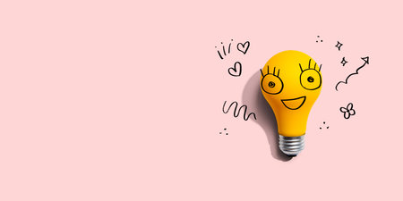 Yellow light bulb with happy faceの写真素材