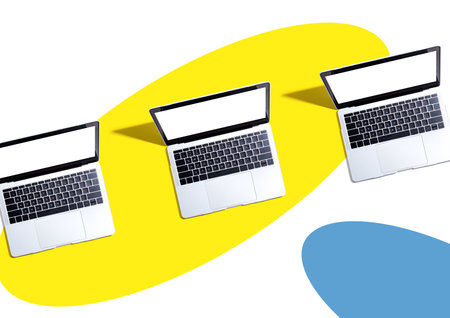 Three laptop computers with shadowの写真素材