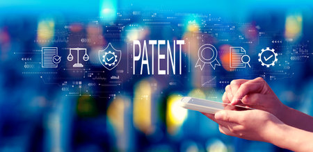 Patent concept with person using a smartphone at nightの写真素材