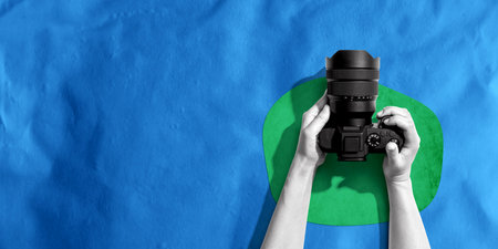 Person holding a SLR cameraの写真素材