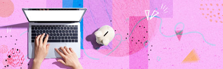 Laptop computer with piggy bankの写真素材