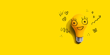 Yellow light bulb with happy faceの写真素材