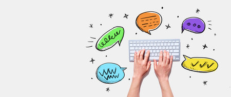 Speech bubbles and a computer keyboardの写真素材
