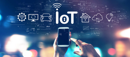 IoT theme with a smartphone in city lights at nightの写真素材