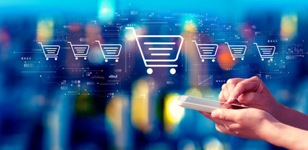 Online shopping theme with person using a smartphone at nightの写真素材