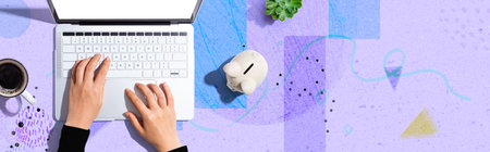 Laptop computer with piggy bankの写真素材