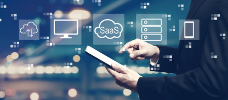 SaaS - software as a service concept with businessman using a tabletの写真素材
