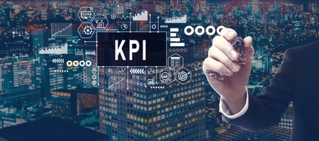 KPI - Key Performance Indicator theme with businessman in city at nightの写真素材