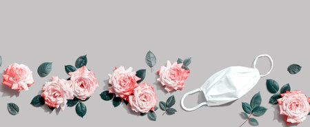 Face mask with pink roses overhead viewの写真素材