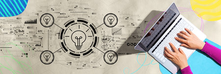 Idea light bulb theme with person using a laptopの写真素材