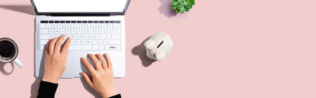 Laptop computer with piggy bankの写真素材
