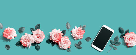 Smartphone with pink roses overhead viewの写真素材