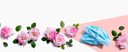 Face masks with pink roses overhead viewの写真素材