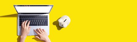 Laptop computer with piggy bankの写真素材