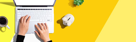 Laptop computer with piggy bankの写真素材