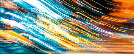 City motion blurred intersection background at night