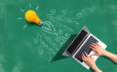 Idea light bulb flying to the sky like a rocket from a laptop computerの写真素材