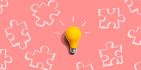 Jigsaw puzzle with a yellow light bulbの写真素材