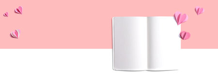 White notebook with paper heartsの写真素材