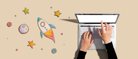 Space exploration theme with rocket and laptopの写真素材