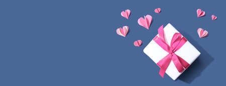 Gift box with pink paper heartsの写真素材