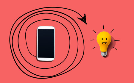 Creativity, inspiration, idea concept with light bulb and smartphoneの写真素材