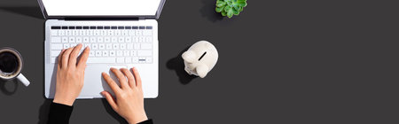 Laptop computer with piggy bankの写真素材