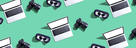 Tech gear theme with vr headset, dslr camera and laptopの写真素材