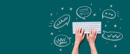 Speech bubbles and a computer keyboardの写真素材