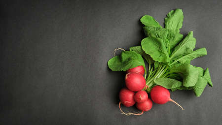 Radish WoodenBackground, red radish on wooden black background, top view