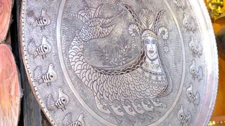 Silver plate with an intricate design.の写真素材