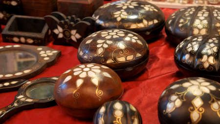 A closeup shot of a set of handmade souvenirs on a red backgroundの写真素材