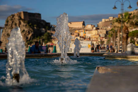 Fountain in Scilla in Calabria, Italy with view on the castle in the background.の写真素材