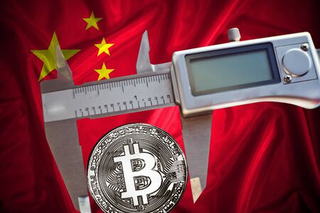Finance concept,Bitcoin on the background a Flag  of China, bitcoin control, bitcoin in a caliper, a board with a trend of crypto currencyの写真素材