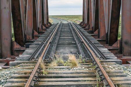 Old railway and railway bridge, rails and pilesの写真素材