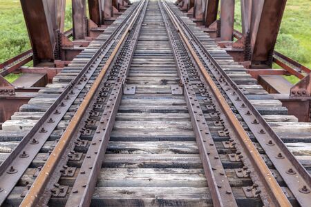 Old railway and railway bridge, rails and pilesの写真素材