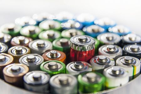 Energy abstract background of colorful batteries.Close-up group of alkaline battery top view. 

Alkaline battery AA size with selective focus on single batteryの写真素材