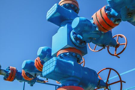 Group wellheads and valve armature , Gas valve, Gas well of high pressure, a wellhead with valve armature. Oil and gas industry concept. Industrial site background. Toned.の写真素材