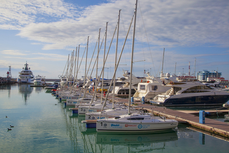 SOCHI,  RUSSIA- 25  december 2017:Marine Station of Sochi, a small sailing boats in Havana Sochi sea port on a background marine station/view of the Harbor Sochi sea port and the marine station buildingのeditorial素材