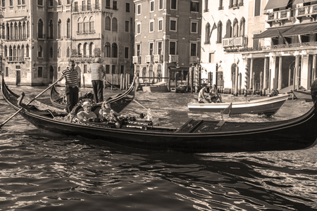Venice.Italy. 23 August -2016:Tourists in gondolas sailing on the grand canal, toned- sepiaのeditorial素材