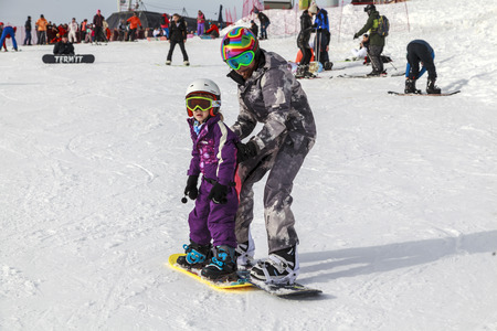 Russia, Sochi, December 01, 2017 - ski resort, instructor is teaching a young girl to ski, instructor is teaching a young girl to ski, Opening of the ski season,editorial.のeditorial素材