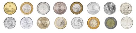A collection different coins of the world, on a white banner, isolated next to each other.の写真素材