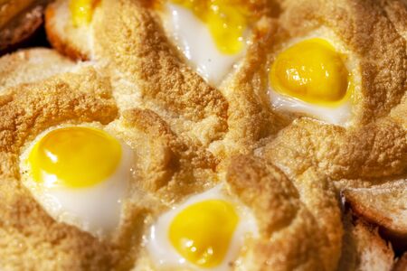 Breakfast, fried eggs with quail eggs with fried whipped whites on breadの写真素材