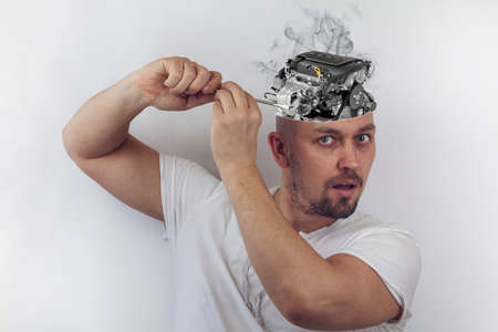 Car repair concept. In the manâ€™s head is a car engine.