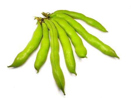 broad beans inside of pods on a white background.