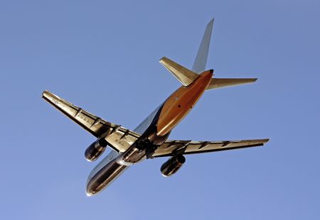 View of a commercial plane departing from the airport, isolated on a blue sky