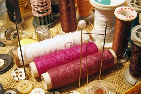 Several sewing material spreaded over the table.