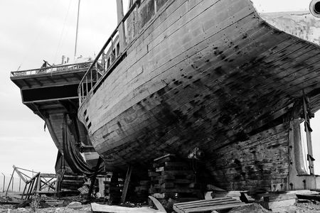 View of two abandoned and broken old boats on a shipyard.の写真素材
