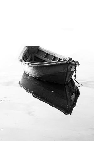 Close view of a traditional portuguese fishing boat anchored on the still water.の写真素材